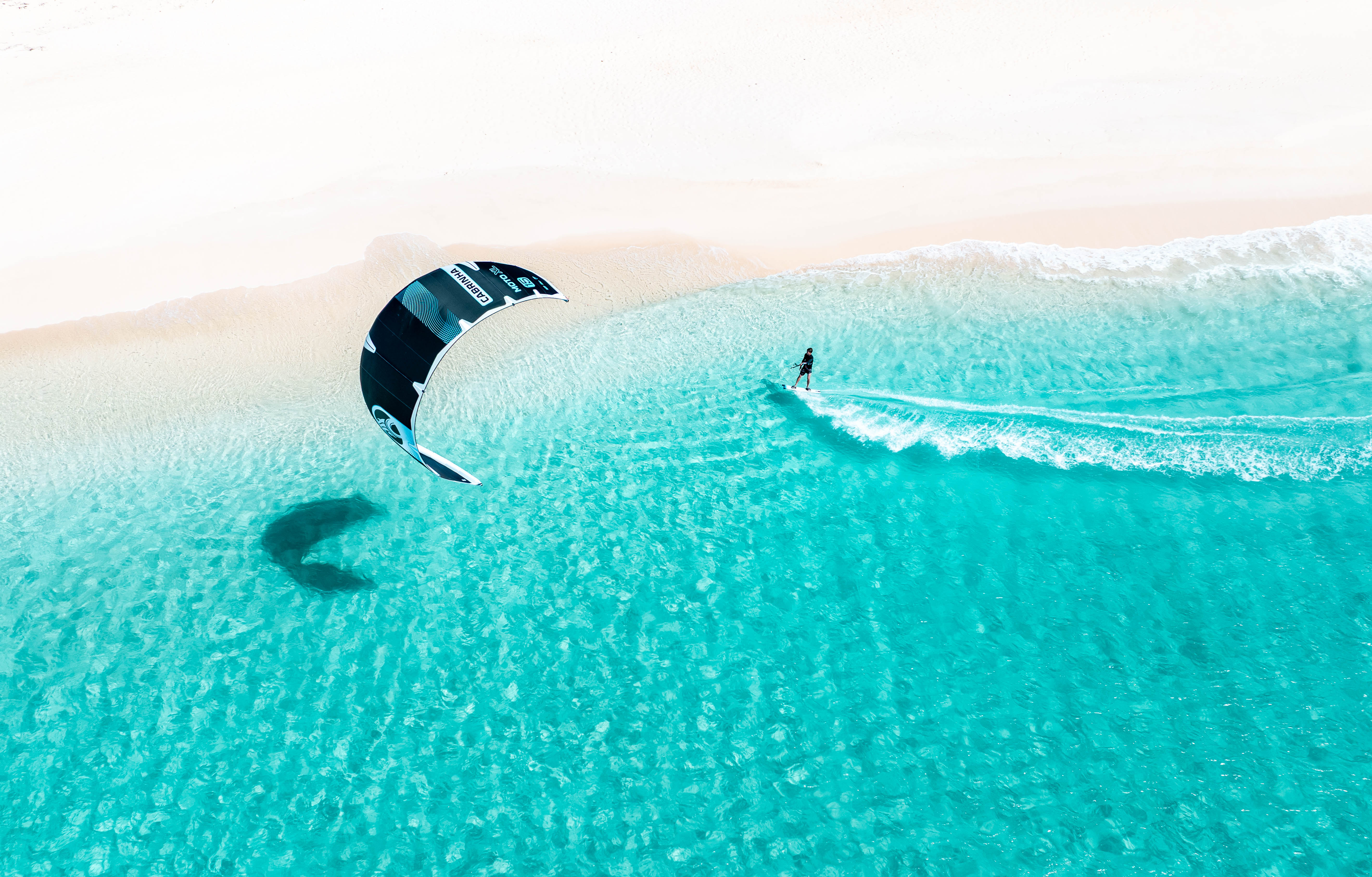 Light wind kitesurfing session on flat turquoise water, Cabrinha light wind gear