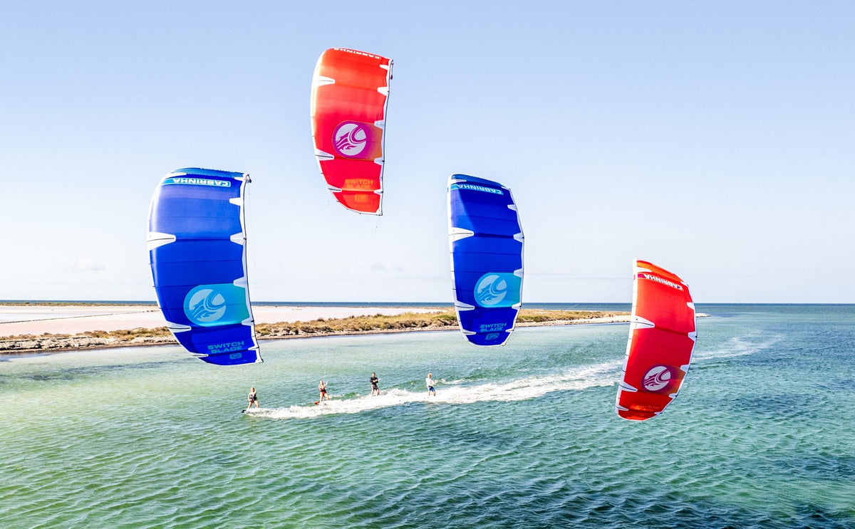 Kitesurfers riding Cabrinha kites with plenty of space over flat, shallow water